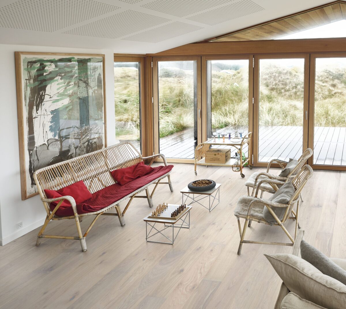 Decorated indoor room with natural lighting and Kahrs Oak Nouveau Blonde Prefinished Hardwood.