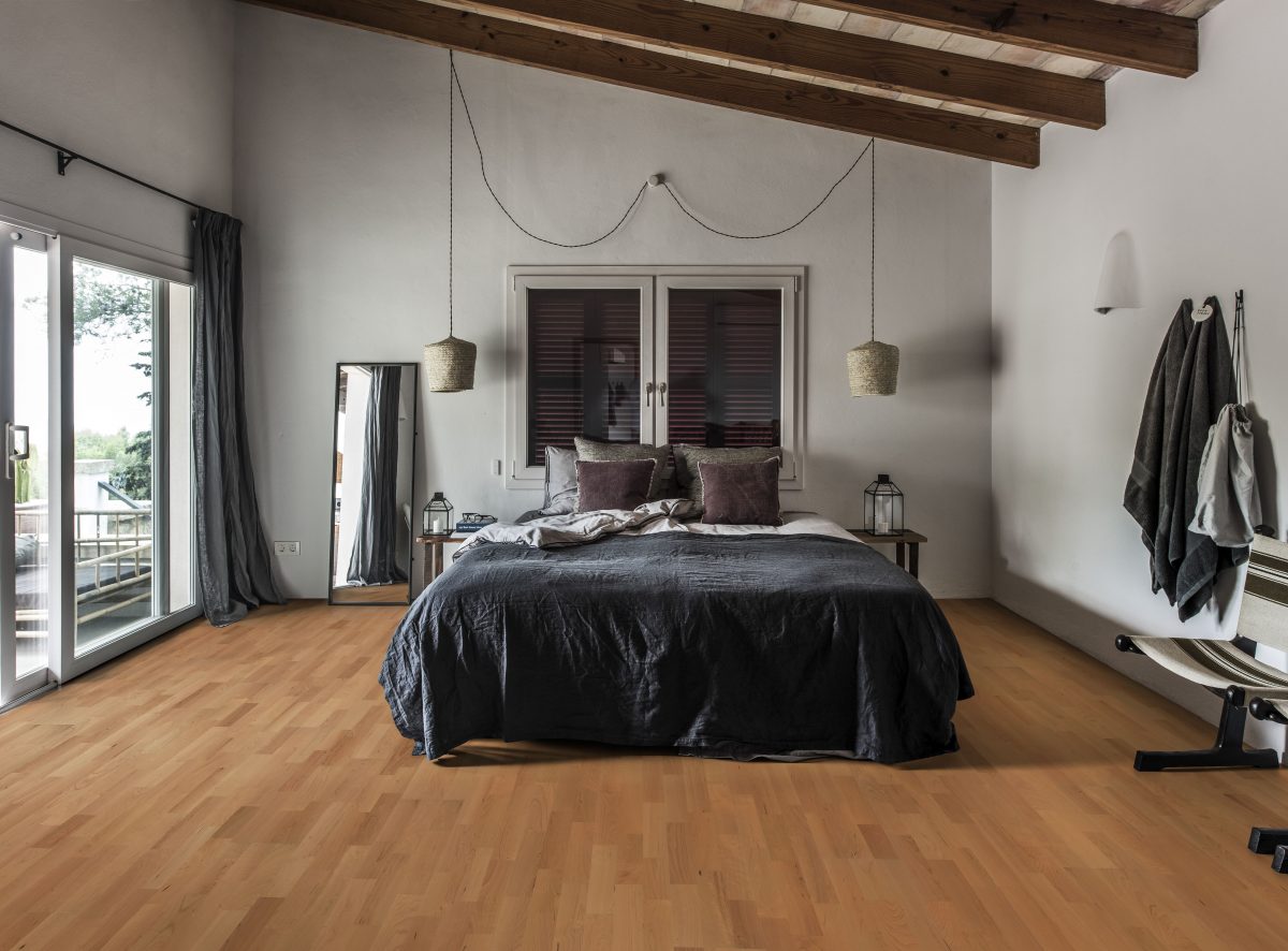 Decorated bedroom space with Kahrs Cherry Savannah Prefinished Hardwood.