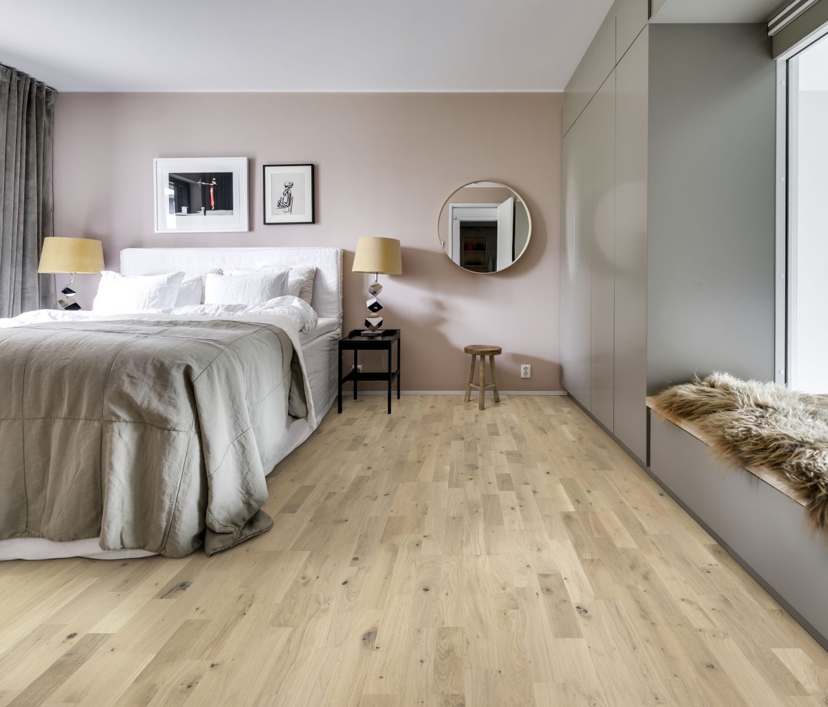 Decorated bedroom space with Kahrs Frosted Oat Strip Prefinished Hardwood.