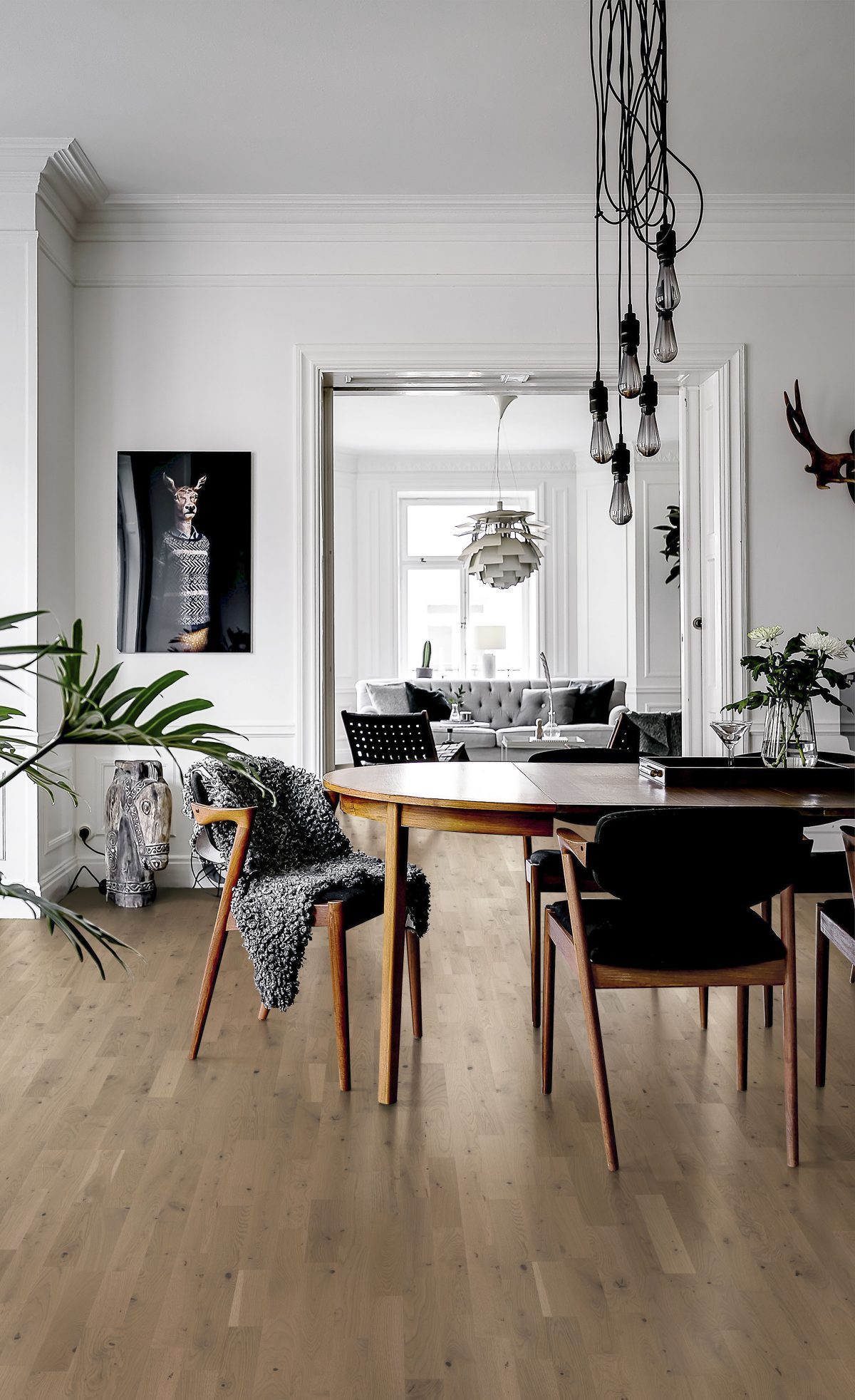 Decorated dining space with Kahrs Frozen Hazelnut Strip Prefinished Hardwood.