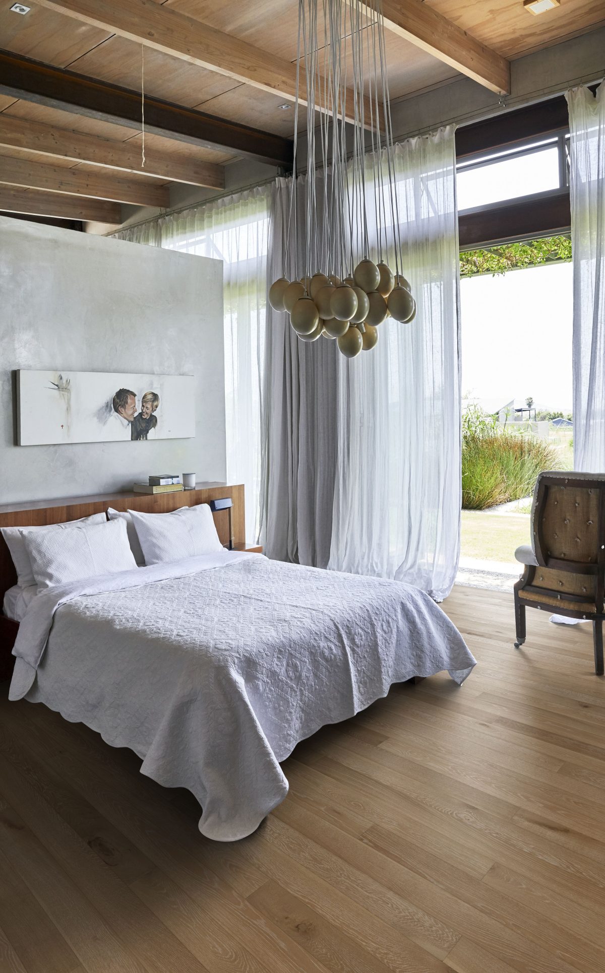 Decorated bedroom space with Kahrs Oak Henna Prefinished Hardwood.