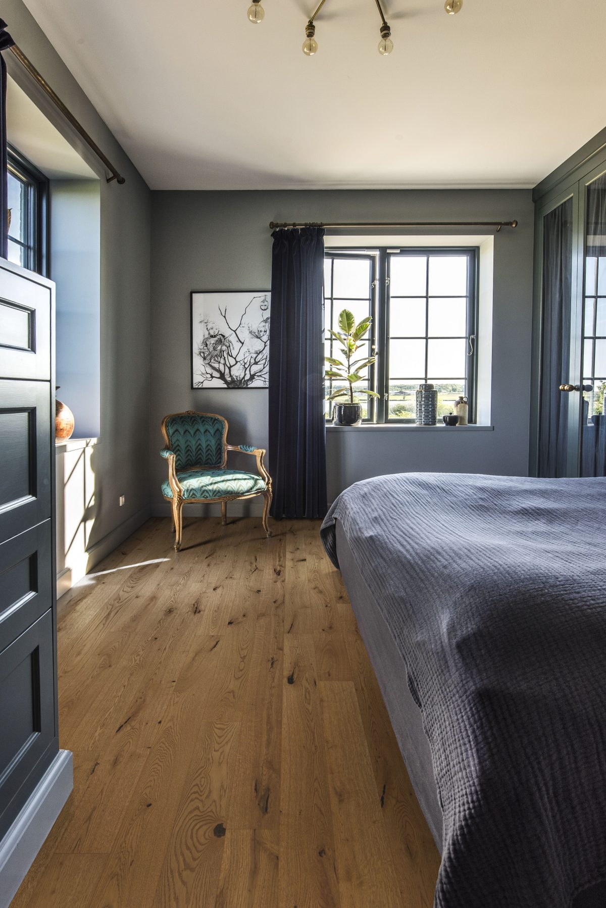 Decorated bedroom space with Kahrs Oak Tuft Prefinished Hardwood.