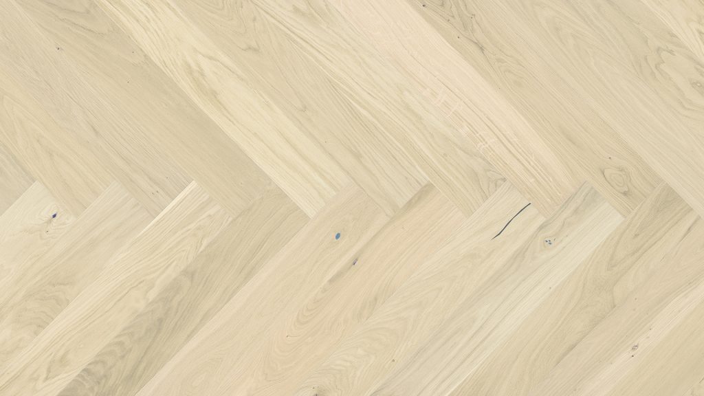 Close up of Barlinek Oak Bianco Herringbone Prefinished Hardwood.