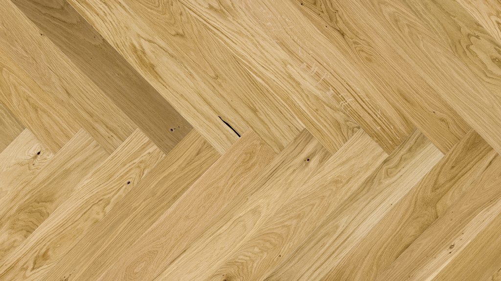 Close up of Barlinek Oak Caramel Herringbone Prefinished Hardwood.